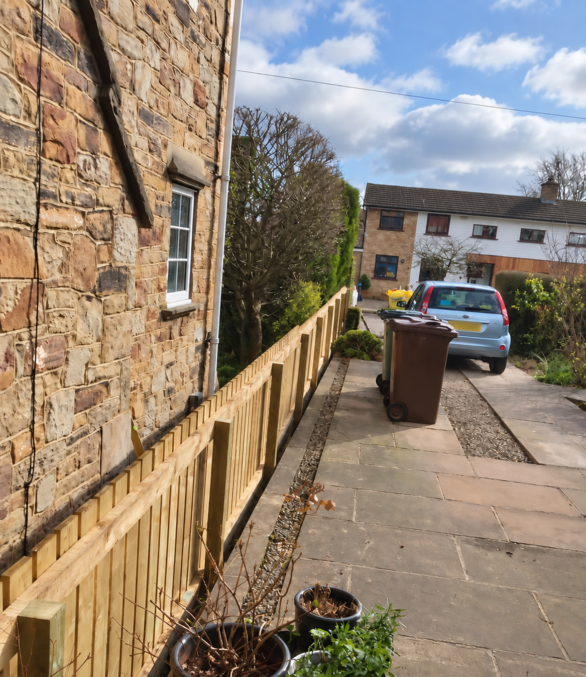 Timber fence posts along a driveway boundary