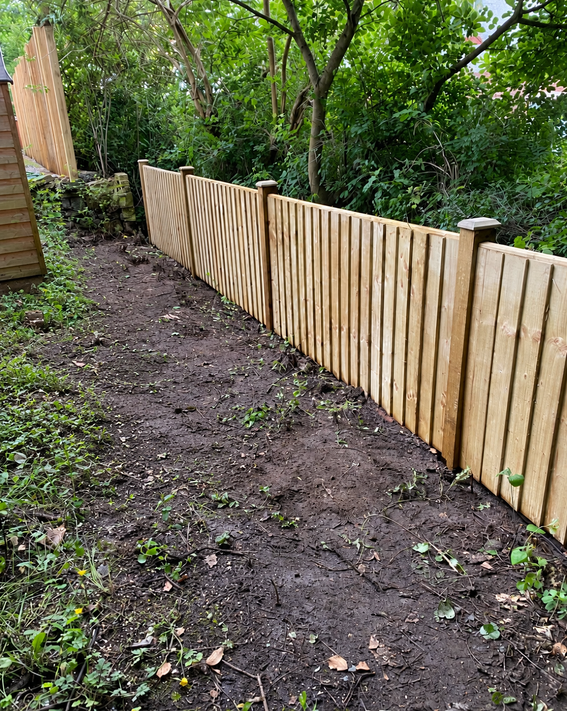 Timber posts and fence panels finished on a residential boundary